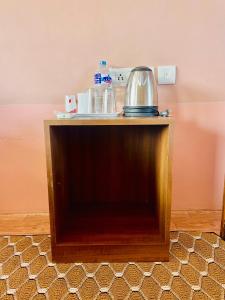 a table with a tea kettle on top of it at Hotel Tree Tops- A Serene Friendly Hotel in Sauraha in Chitwan