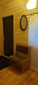 a room with a bench and a mirror and a door at Pirts,kubls,,Saknēs,, in Talsi