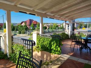 a patio with chairs and a table on a porch at Taverna 1860 Rooms & Apartments in Donja Zelina