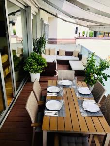 a wooden table and chairs on a balcony at Sky View Salzburg in Salzburg