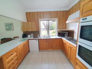 a kitchen with wooden cabinets and a white appliance at Sunbury Central in Sunbury