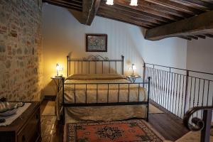 a bedroom with a bed and two lamps and a staircase at Hotel & SPA L'Antico Forziere in Deruta