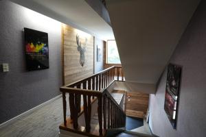 a hallway with a staircase with paintings on the walls at Auberge Le Semnoz in Saint-Jorioz