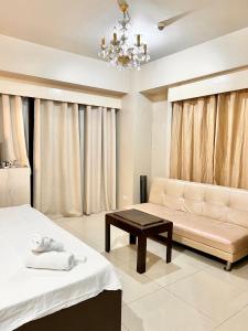 a living room with a couch and a table at Newport Hotel near NAIA Manila Airport Terminal Pasay in Manila