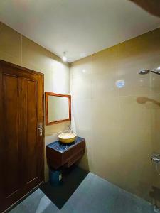 a bathroom with a sink and a shower at Batur Volcano Guesthouse in Kintamani