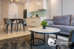 a living room with a couch and a table at Sentral Suites by Plush in Kuala Lumpur