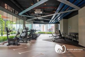 a gym with treadmills and elliptical machines at Sentral Suites by Plush in Kuala Lumpur