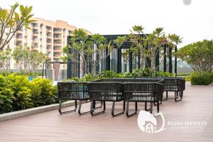 a group of benches sitting on a boardwalk at Sentral Suites by Plush in Kuala Lumpur