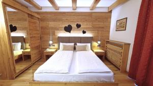 um quarto com uma cama num quarto de madeira em Park Hotel Sport em Andalo