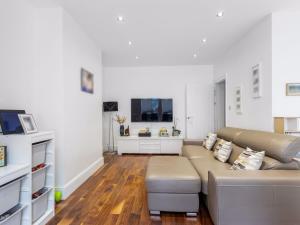 a living room with a couch and a tv at Willow Road Enfield Town Greater London in Enfield
