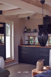 a kitchen with a large vase hanging from the ceiling at Nordicstay Noarootsi Kastehein or Loojangu villa in Paslepa