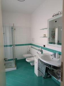 La salle de bains est pourvue de 2 toilettes, d'un lavabo et d'une douche. dans l'établissement Appartamento Casa Verona, à Vérone