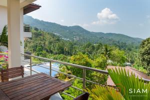 a balcony with a table and a view of the mountains at Chaweng Hill 2Br in Koh Samui