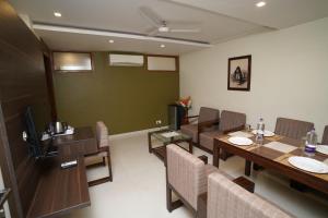 a dining room with a table and chairs at Hotel Metropolis in Hubli