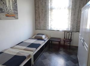 a small room with a bed and a window at Apartment Essen-City in Essen