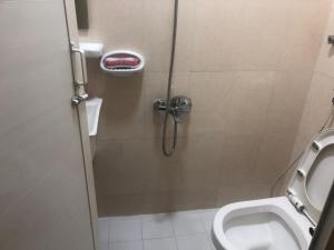 a bathroom with a shower stall with a toilet at Dubai NorthStar Hostels in Dubai