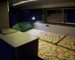 a small room with a bed and a desk at Camper en Guadarrama in Manzanares el Real