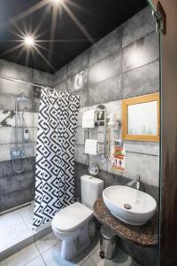 a bathroom with a white toilet and a sink at Ego Hotel Буковель in Yablunytsya