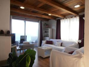 a living room with white furniture and large windows at Atlantic paradise in Los Realejos