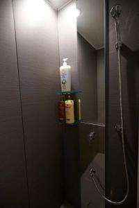 a bathroom with a shower with a sink and a mirror at 634 Condo Shinjuku - Vacation STAY 01902v in Tokyo