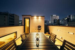 a table on a balcony with a view of a city at 634 Condo Shinjuku - Vacation STAY 14798v in Tokyo
