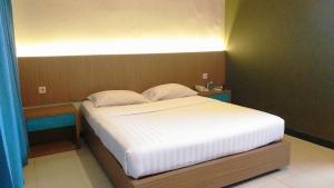 Krevet ili kreveti u jedinici u okviru objekta Cakra Kusuma Hotel