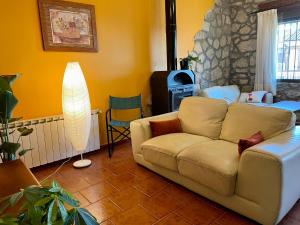 a living room with a couch and a fireplace at Luna de Gredos in Pedro Bernardo