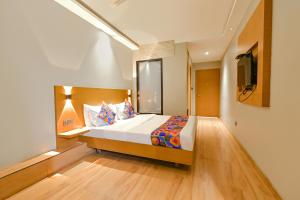 a bedroom with a bed and a television in it at FabHotel Penthouse in Guwahati