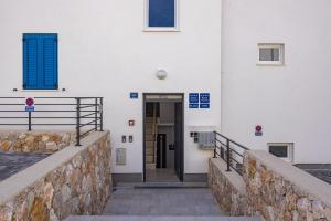 a building with a door in the side of it at Apartments Tim & Klara - Sunny Cres Island in Cres