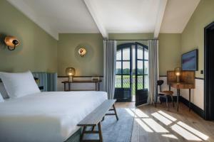 a bedroom with a white bed and a window at Ultimate Provence Hotel & Spa in La Garde-Freinet