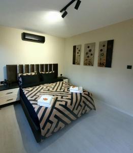 a bedroom with a bed with a black and white comforter at Calm & Cosy Flat in Perfect Location Nişantaşı in Istanbul