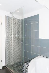 a bathroom with a shower with a glass door at Unter den Sternen in Bottrop