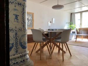 a dining room with a table and chairs at Historical and Modern Flat by Zytglogge - 2nd floor in Bern