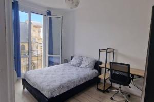 um quarto com uma cama, uma secretária e uma cadeira em F4 - La Maison de M. Goéland em Le Havre