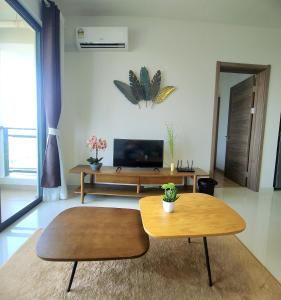 a living room with a table and a tv at Seaview Regalia Park, (Happy House), Full Furnished, Free WiFi Forestcity in Gelang Patah