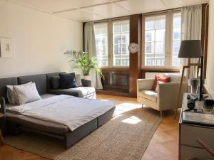 a living room with a bed and a couch at Historical and Modern Flat by Zytglogge - 2nd floor in Bern