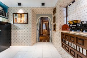 a kitchen with tiled walls and a hallway at 16 San Sebastian in Mijas