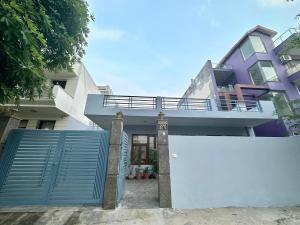 a house with a blue gate and a fence at cozy room with no restrictions in Gurgaon