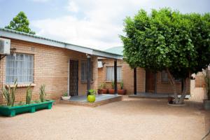 a brick house with a tree in front of it at The Cosy Crib in Palatswe