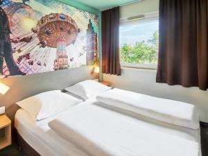 Кровать или кровати в номере B&B Hotel Darmstadt