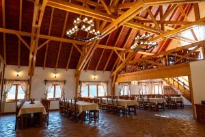 a dining room with tables and chairs in a building at 5.Evszak in Sfântu-Gheorghe