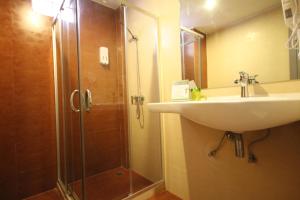 a bathroom with a shower and a sink and a shower at KRABI CHARM in Ban Khlong Haeng
