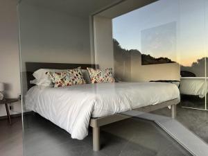 a bedroom with a large bed with a large window at Il Mare di Giù Boutique Guesthouse in Licata