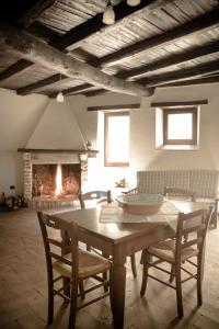 a living room with a table and a fireplace at Borgo San Valentino in Arrone