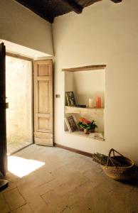 a room with an open door and a room with a window at Borgo San Valentino in Arrone