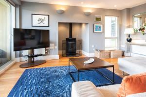 a living room with a couch and a tv at Clearwater 82, Primrose Bank in Somerford Keynes