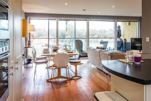 a room with tables and chairs and a large window at Clearwater 82, Primrose Bank in Somerford Keynes