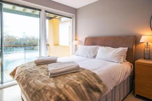 a bedroom with a large bed with two pillows on it at Clearwater 82, Primrose Bank in Somerford Keynes +17 photos