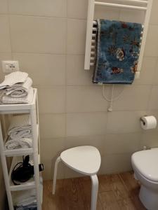 a small bathroom with a toilet and a stool at Via Guido Panciroli il guscio in Reggio Emilia