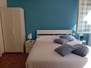 a blue bedroom with a bed with two pillows at Via Guido Panciroli il guscio in Reggio Emilia